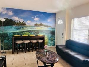 a living room with a painting on the wall at Delray, easy walk to downtown, free parking (315W) in Delray Beach