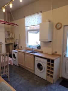 a kitchen with a sink and a washing machine at No 3 Lingdale - 4 bedroom house close to N Yorks Moors in Boosbeck