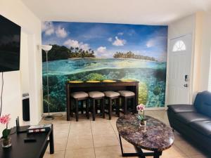 a living room with a painting on the wall at Delray, easy walk to downtown, free parking (315W) in Delray Beach