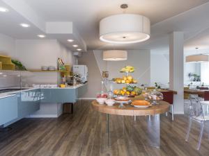 a kitchen with a table with fruit on it at Hotel Ca' Mura in Bardolino