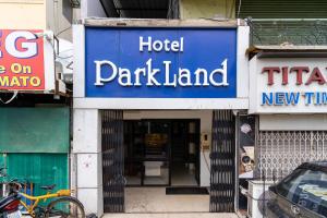 a hotel parkland sign in front of a building at Hotel Parkland Manage by G Express in Ahmedabad