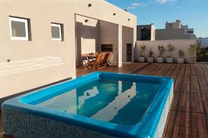 a blue swimming pool on the roof of a house at 2415 Palermo in Buenos Aires