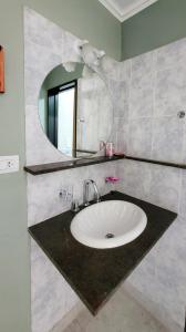 a bathroom with a sink and a mirror at Alquileres Grutenses in Las Grutas