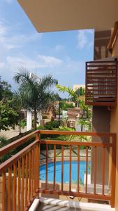 a balcony with a view of a swimming pool at 2 Bedroom and 1 Bedroom Apartments with Private Pool and Gym in Puerto Princesa City