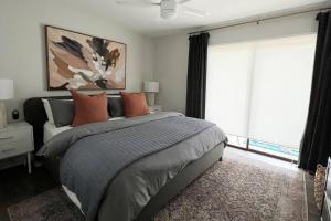 a bedroom with a bed and a large window at High design & coziest comforts in Gainesville