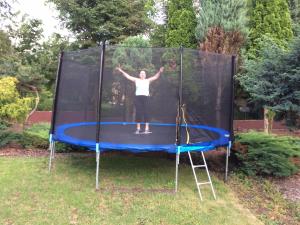 a woman is standing on a trampoline at Chybotek Premium in Przesieka