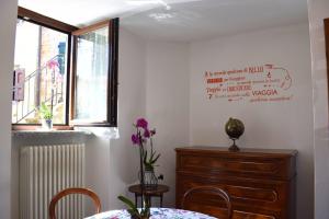 a dining room with a table and a dresser and a window at IL GINEPRO B&B in Piamaggio