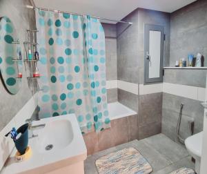 uma casa de banho com um lavatório e um chuveiro em Apart haut standing v mer em Sousse