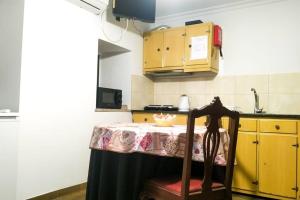 a kitchen with a table and a chair in it at Casa das Matriarcas - Casa da Avó Elisinha in Belmonte