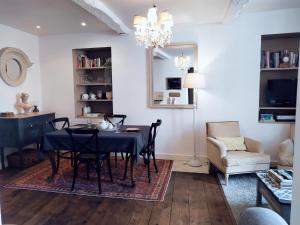 a dining room with a black table and chairs at Maison Nº 20 in Eymet