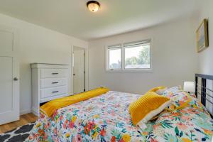 a bedroom with a bed and a window at Rustic Retreat in Spokane Valley with Cozy Fireplace in Spokane Valley