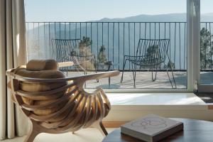 a room with a balcony with a table and chairs at Casa de São Lourenço - Burel Panorama Hotel - member of Relais & Châteaux in Manteigas +90 photos