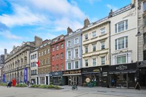 a row of buildings on a street in a city at Covent Garden Superior Two Bedroom Aparment on Strand in London