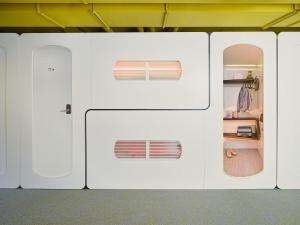 a white refrigerator with two windows in a room at CityHub Rotterdam in Rotterdam