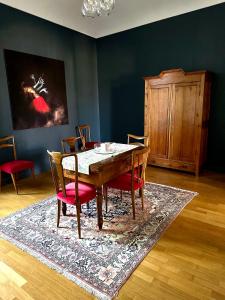 a dining room with a table and chairs on a rug at Casa Piolti Rivoli in Rivoli