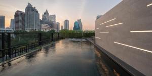 a pool of water with a city in the background at PASSA Hotel Bangkok in Bangkok