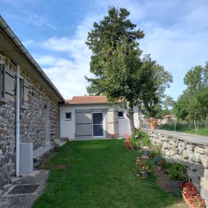a house with a yard with a stone wall at Boufavent in Salettes +11 photos