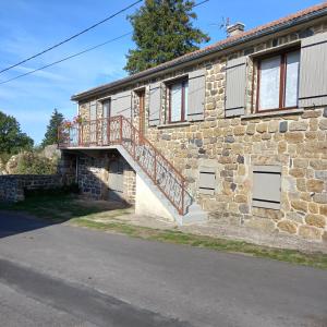 a stone house with a staircase on the side of it at Boufavent in Salettes