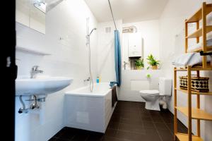 a bathroom with a sink and a toilet at Luxury Suites Stay in Antwerp