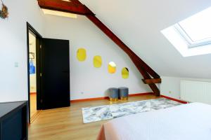 a room with a bed and a staircase with yellow circles on the wall at Luxury Suites Stay in Antwerp