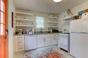 a kitchen with white cabinets and a white refrigerator at Tangerine Bungalow Downtown Hot Springs in Hot Springs