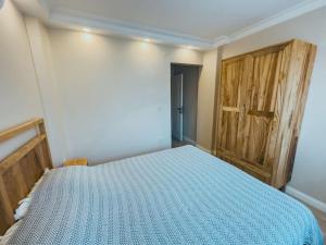 a bedroom with a bed and a wooden door at Central, Spacious with Balcony & Elevator Flat in Beşiktaş in Istanbul