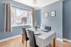 a dining room with a table and chairs and a window at Jefferson 4 Bed, 5 Guests in Goole
