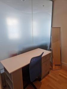 an office with a desk and a blue chair at Spacious 1bed Apt in Leeds City Centre in Leeds
