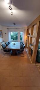 a living room with a dining room table and chairs at Haus auf der Schwäbischen Alb in Grabenstetten