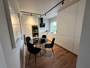 a kitchen with a table and chairs in a room at Urriðafoss Waterfall Villa in Selfoss