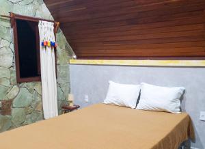 a bedroom with a bed with a wooden ceiling at Recanto Alto da Serra in Portalegre