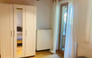 a room with a closet and a bedroom with a window at Sonnenuntergang in Traunstein