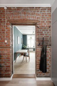 an open brick wall in a room with a table at Botanical garden apartments in Oslo