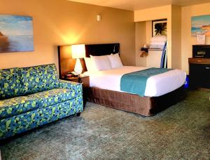 a hotel room with a bed and a couch at Old Town Inn in San Diego