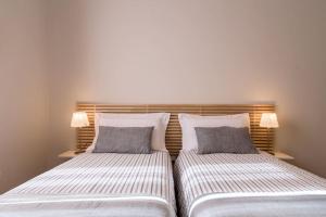 2 nebeneinander sitzende Betten in einem Schlafzimmer in der Unterkunft Marsala Flexyrent apartment in Mailand