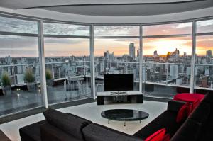 a living room with a view of a city at Holiday Inn Rosario, an IHG Hotel in Rosario