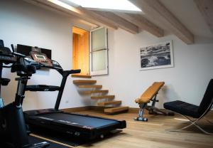 a room with a gym with a treadmill and a desk at RESIDENZA BALIOS in Vaglio di Basilicata