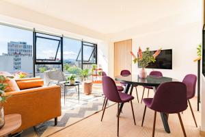 a living room with a table and chairs at NEW La Roma Penthouse 100m2 Terrace Pool and Gym in Mexico City