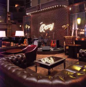 a living room with a couch and a brick wall at Roxy Hotel New York in New York