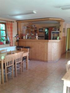 a kitchen and dining room with a table and chairs at Pension U Štěpánků in Trpišovice