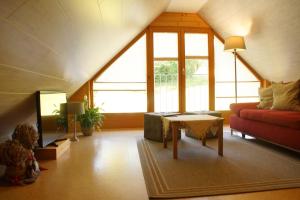 a living room with a red couch and a table at Ferienhaus Zwickelreith in Göstling an der Ybbs