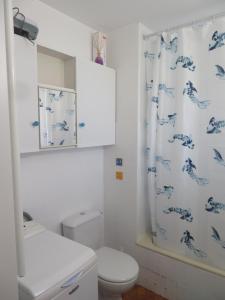 a bathroom with a toilet and a shower curtain at Studio week-end mer in Saint-Cyr-sur-Mer