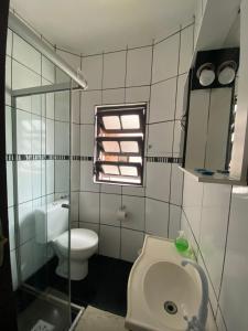 a bathroom with a toilet and a sink at Apartamento Marisco in Torres