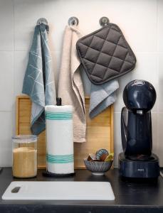 a kitchen counter with a coffee maker and towels at Bord de mer- Studio avec jardin in Roquebrune-Cap-Martin