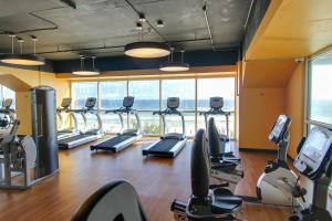 a gym with treadmills and ellipticals in a building at Splash Beach Resort by Panhandle Getaways in Panama City Beach