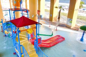 a water park with a slide in the water at Splash Beach Resort by Panhandle Getaways in Panama City Beach