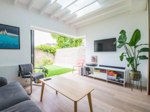a living room with a couch and a table at Pass the Keys Peckham House with garden London in London