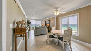 a dining room with a table and chairs and the ocean at Destin on the Gulf 607 - Updated Gulf Front Property at Destin on the Gulf in Destin