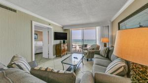 a living room with a couch and chairs and a television at Destin on the Gulf 607 - Updated Gulf Front Property at Destin on the Gulf in Destin
