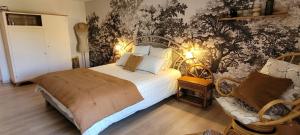 a bedroom with a large bed and a couch at Chambre d'hôte à "Tandem House" in Saint-Rambert-sur-Loire